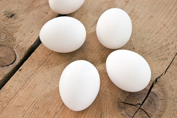 Chicken white eggs on wooden background