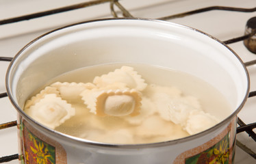 the dumplings cooks in a pan with the boiling water