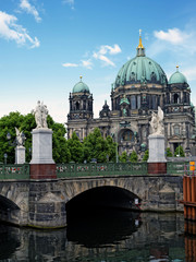 Fototapeta na wymiar Palace Bridge (Schlossbruecke) over a western branch of the Spree River with Berlin Cathedral in the background 