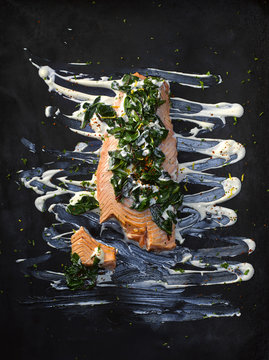 Food art, salmon with chard, chili flakes, lemon peel, herbs, horseradish and remoulade