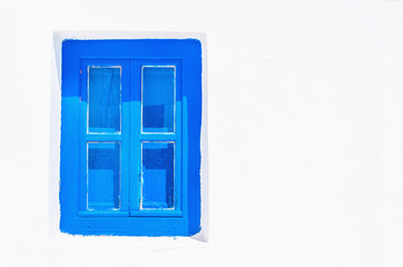 Blue wooden window with clear white wall, Greece