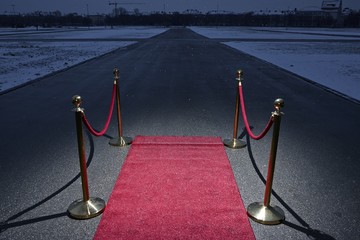 Red carpet on street, city in the background