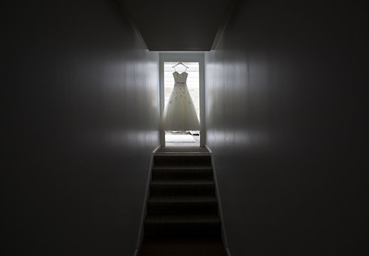 Wedding dress hanging in door case