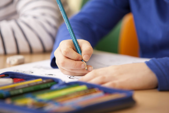 Pupils working on work sheets in classroom