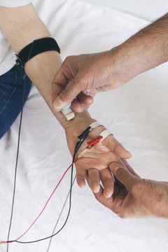 Chiropractor performing a Median NCV electrotherapy