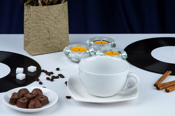 Empty coffee cup,coffee beans,cinnamon and candles