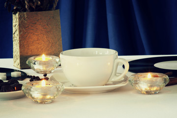 Empty coffee cup,coffee beans,candles and cinnamon