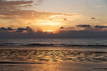 Surfers in sunset, Donostia, Spain.