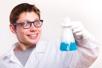 Surprised chemist in laboratory holding test tube during the rea