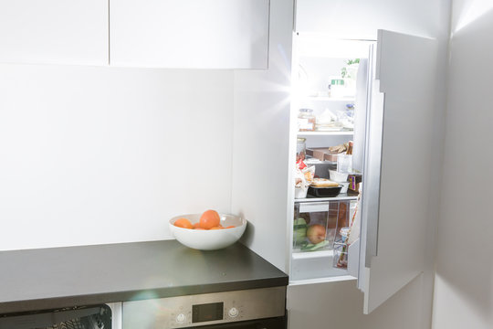 Modern kitchen, open fridge and light