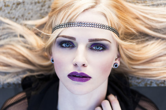 Portrait of rouged blond woman with hair-band
