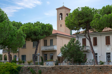 Fototapeta na wymiar Nice view of the house and the bell tower of the church in the resort town of Rimini. Italy