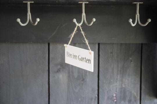 Sign hanging on coat rack