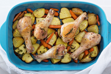 Roasted chicken legs with carrot and potato
