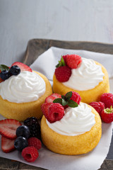 Pastry cups filled with cream and fresh berries