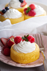 Pastry cups filled with cream and fresh berries
