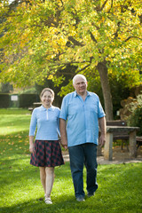 woman and  senior man   walking in  park.