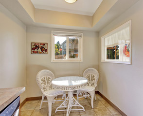 Extra dinning area with white chairs and table.