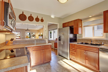 Modern kitchen with tile floor. Modern kitchen with tile foor with wooden cabinets.