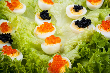 Quail eggs served with salmon, trout and sturgeon caviar