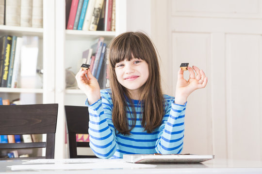 Portrait of smiling girl showing stamps