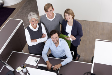 Smiling business team at desk in office