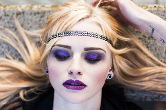 Portrait of rouged blond woman with hair-band