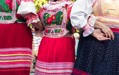 Anonymous senior female friends in folklore costumes