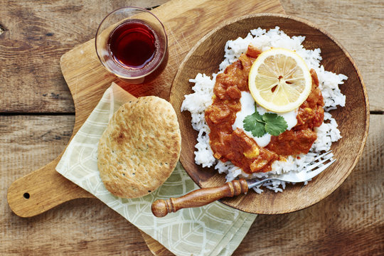 Seitan Tikka Masala on rice with soy yogurt and served with paratha breads and tea