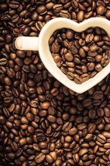 White cup on coffee beans background