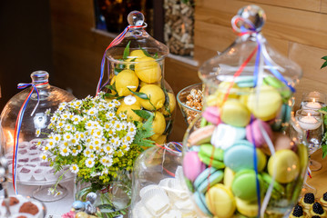 Fresh lemons in candy bar/lemons in a glass vase and other sweets in candy bar