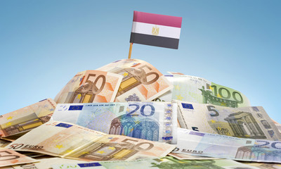 Flag of Egypt sticking in a pile of various european banknotes.(