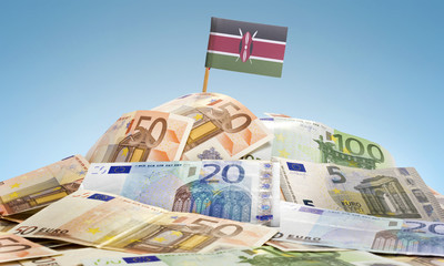 Flag of Kenya sticking in a pile of various european banknotes.(