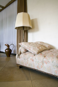 Old-fashioned couch and floor lamp in a living room