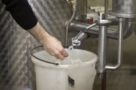 Distiller in distillery testing schnapps
