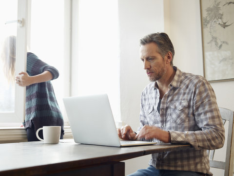 Germany, Cologne, Mature Man And Adult Daughter Surfing The Web