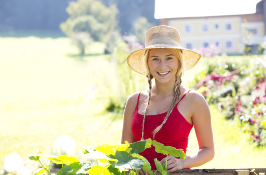 Portrait of smiling teenage girl gardening
