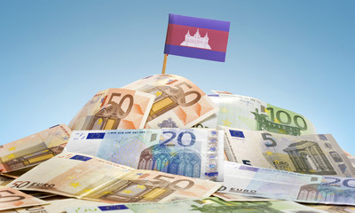 Flag of Cambodia sticking in a pile of various european banknote