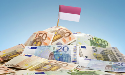 Flag of Indonesia sticking in a pile of various european banknot
