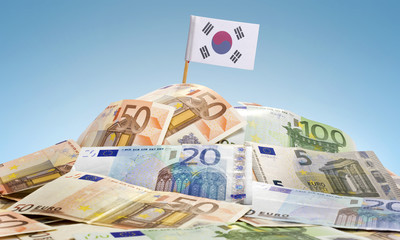 Flag of South Korea sticking in a pile of various european bankn