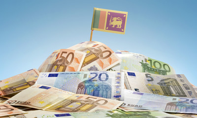 Flag of Sri Lanka sticking in a pile of various european banknot