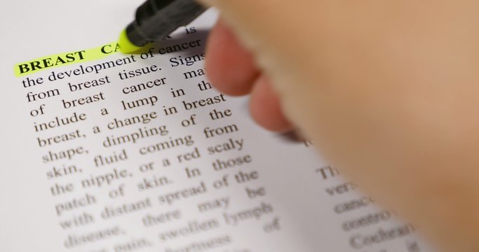 The definition of Breast Cancer being emphasized by a yellow marker