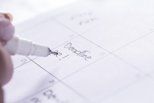 Woman noting date in day planner