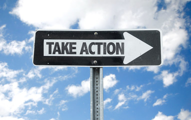 Take Action direction sign with sky background