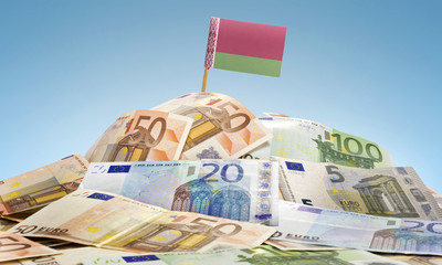 Flag of Belarus sticking in a pile of various european banknotes