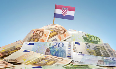 Flag of Croatia sticking in a pile of various european banknotes