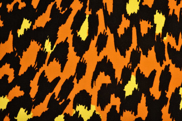 Orange and yellow leopard pattern. Colorful spotted animal print as background.