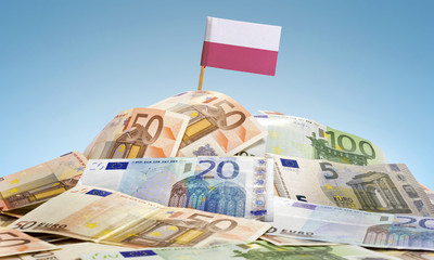 Flag of Poland sticking in a pile of various european banknotes.