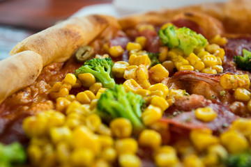 Pizza with salami, sweetcorn and broccoli