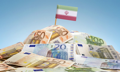 Flag of Iran sticking in a pile of various european banknotes.(s